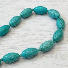 "Chunky Turquoise Necklace, Turquoise Oval Necklace, Classic Necklace, Large Turquoise Necklace, Turquoise Barrel Necklace, Everyday Necklace This timeless necklace was hand beaded using gorgeous 25x15mm round turquoise howlite barrel shaped gemstones separated by smaller turquoise beads. These gemstones are unique in their design and pattern - each is exquisite! The necklace measures your choice of 16 - 19 inches in length and is fastened by a silver lobster clasp. It frames the face beautifull Turquoise Necklace With Oval Beads For Gift, Turquoise Oval Natural Stones Necklaces, Turquoise Necklaces With Oval Natural Stones, Turquoise Oval Necklaces With Natural Stones, Oval Turquoise Natural Stone Necklaces, Oval Turquoise Necklaces With Natural Stones, Turquoise Necklace With Oval Gemstone Beads For Gift, Turquoise Necklace With Oval Gemstone Beads As A Gift, Polished Oval Beads Turquoise Necklace For Gift