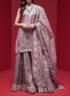 "Material: High-quality Raw silk This ensemble features a pink shirt that exudes grace and elegance, with captivating patterns created by intricate embroidery and shimmering sequin embellishments. It is paired with a modern sharara, beautifully contrasted, and adorned with floral prints. To complete the formal look, there is a classic dupatta elegantly draped, showcasing dazzling floral embroidery. Color : purple/Levander Occasion: Ideal for weddings, parties, or cultural events Ready to wear, no hassle of stitching Comfortable and easy to move in Exquisite craftsmanship Care Instructions: Dry clean only for long-lasting beauty and durability  the color of the product in the photo might look slightly different in person due to factors like lighting and screen settings.\"	in stock	175.00 US Unstitched Dola Silk Palazzo Set For Reception, Wedding Palazzo Set With Dupatta In Jamawar, Wedding Jamawar Palazzo Set With Dupatta, Pink Georgette Palazzo Set With Sheer Dupatta, Pink Chanderi Dress With Intricate Embroidery, Unstitched Sharara With Resham Embroidery For Reception, Unstitched Jamawar Palazzo Set For Wedding, Elegant Jamawar Palazzo Set For Wedding, Pink Dola Silk Sharara With Resham Embroidery