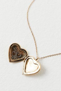 A super sweet gift or an accessory unique to you, this darling monogram necklace features a heart locket pendant with an initial engraving. **Features:** Dainty chain, heart locket pendant, hinge opening mechanism, monogram initial engraving, clasp closure **Why We | Monogram Necklace by Free People in Gold Vintage Charm Heart Pendant Jewelry For Keepsake, Vintage Heart Pendant Charm Jewelry For Keepsake, Vintage Charm Pendant Jewelry For Anniversary Gift, Wedding Locket Necklace With Charms For Valentine's Day, Vintage Pendant Jewelry For Anniversary Gift, Anniversary Gift Pendant Jewelry With Vintage Charm, Valentine's Day Wedding Locket Necklace With Charms, Heart-shaped Vintage Charm Jewelry For Keepsake, Vintage Personalized Open Heart Jewelry