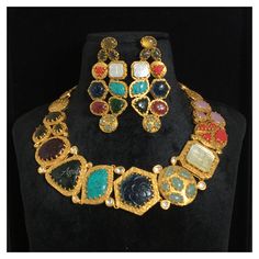 *Material: Brass *Plating: 22K Gold Plated *Stone: Semi Precious Gemstones *DIMENSIONS * *Necklace : Weight 83 gm *Earrings : Length 2.75 Inches , Width 1.25 Inches , Weight 15 gm Each *ABOUT PRODUCT* *This is a High Quality Navratan Necklace Set. *Style Tip : If you like both Traditional and contemporary... This set is certainly for you. *DISCLAIMER* *Product & color may slightly vary due to photographic lighting sources or your screen settings. Traditional Gemstone Necklaces For Formal Occasions, Traditional Gemstone Necklace For Formal Occasions, Ceremonial 22k Gold Multicolor Jewelry, Gold Plated Bollywood Style Necklace, Gold Plated Heavy Bollywood Necklace, Heavy Gold Plated Bollywood Necklace, Heavy Bollywood Style Gold-plated Necklace, Gold Kundan Necklace With Gemstones For Ceremonial Wear, Gold Kundan Necklace With Gemstone For Ceremonial Occasions