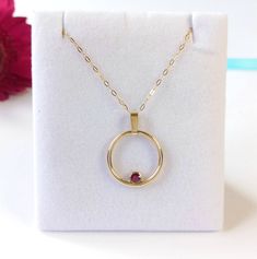 Feel fabulous in this solid 9ct yellow gold and ruby circular pendant.  Named the 'Oriana Rose', meaning Golden Sunrise, this pendant shimmers and shines around your neck, evoking a real festive feel. Symbolising the circle of life in a year, the Oriana Rose is an ideal Valentine's Day gift. The ruby is a rich and vibrant red; red being the colour of  love and glints beautifully in its rub over setting. You don't need to worry about buying the correct size; this pendant fits all and has a clip on bail so you can wear it with or without the bail and includes the chain photographed. So why do you need this pendant?  A ring might not be the exact message you want to convey and bracelets are tricky to size as well. This pendant is on trend, but is unique in its design. My silver and gold penda Life In A Year, Rose Meaning, Golden Sunrise, Trendy Jewellery, Gold Gifts, Ruby Necklace, Shimmer N Shine, Circle Of Life, Circle Necklace