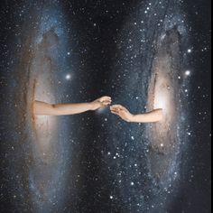 two hands reaching out towards each other in front of stars