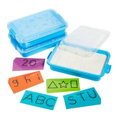 two plastic containers filled with different types of letters and numbers on top of each other