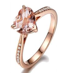 a rose cut morganite ring with diamonds on the sides and an oval pink diamond in the center