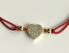 18k gold plated over 925 sterling silver heart red bracelet .adjustable . for love and happiness. --comes with free gift pouche. pulsera rojo de plata esterlina 925 con baño de oro corazon . ajustable. para amor y felicidad. --gratis bolsa de regalo. Fine Jewelry Bracelets With Charms For Gift, Fine Jewelry Charms Bracelets As Gift, Red Heart Charm Fine Jewelry, Heart-shaped Cubic Zirconia Bracelets For Gifts, Heart-shaped Yellow Gold Bracelets With Cubic Zirconia, Red Fine Jewelry With Heart Charm, Heart-shaped Yellow Gold Cubic Zirconia Bracelets, Yellow Gold Heart-shaped Cubic Zirconia Bracelets, Adjustable Silver Heart Bracelet Gold Plated