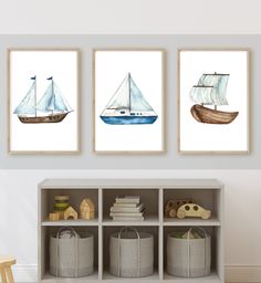 three watercolor sailboats are hanging on the wall next to bookshelves in a child's room