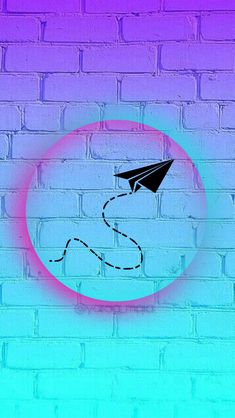 a paper airplane is flying through the air over a brick wall with a pink circle around it