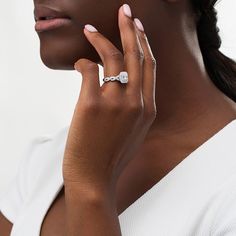 a woman wearing a diamond ring on her finger