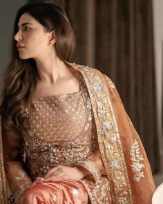 Traditional Caramel Embroidered Pishwas Pakistani Wedding Dress is an elegant ensemble in the hues of beige. The silhouette consists of a organza bodice layered with two pannals and shabnum lehenga with embroidered and elaborated pearls, kutdana and sitara work, further enhanced with masuri finishing in metallic gold. Pakistani Wedding Frock: The Pakistani Frock in open style has an alluring caramel shade and an organza fabric. This beautiful Pishwas Frock is hand-embellished with pearls, sequin Pishwas Pakistani, Pakistani Frocks, Sitara Work, Wedding Dresses Pakistani, Wedding Frocks, Desi Wedding Dresses, Asian Wedding Dress, Pakistani Wedding Dress, Pakistani Bridal Dresses