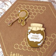 a close up of a card with a honey jar on it and a key in the middle