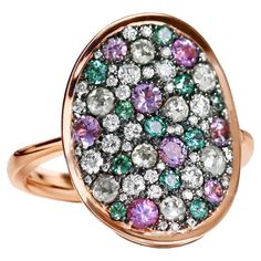 Crafted in 18K Rose Gold, this ring features rare Alexandrite from Brazil with its mesmerizing color shift, unheated purple sapphires, and a stunning mix of rose and brilliant-cut diamonds. Every gemstone is carefully chosen for its unique beauty. This piece by Joke Quick is handcrafted in Belgium, without casting or 3D printing. Our signature mosaic setting ensures a seamless sparkle that won’t snag on clothes. Designed to follow your finger’s natural curve, this ring offers a perfect, comfortable fit. 18K Rose gold: 9.2 g 7 X Natural icy Tambuli rose-cut diamonds: 0.47 ct. 43 X Natural white DEGVVS brilliant-cut diamonds: 0.40 ct 8 X No heat Purple sapphire: 0.48ct. 11 X Round cut colorchanging Alexandrite from Brazil : 0.26 ct. Total carat diamonds: 0.87 ct. Total carat Gemstones: 0.74 Diamond Pave Ring, Pave Diamond Ring, Purple Sapphire, Modern Ring, Pave Ring, Unique Beauty, Natural Curves, Rose Cut Diamond, Modern Fashion