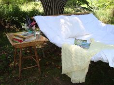 there are pictures of people sitting in the grass with umbrellas and books on their laps