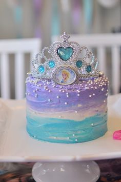 there is a cake that has been decorated with princess tiara on top of it