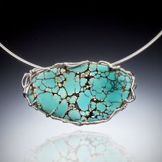 Silver & Stone Necklace - A spectacular spiderweb Carico Lake turquoise cabochon is nested in a sterling silver branch setting in this one-of-a-kind pendant. The design complements the mineral veins found in this dramatic stone. A simple 2mm sterling silver wire choker holds the pendant, which has large loops in back and can be worn on a chain as well. In turn, the choker can be used for other pendants or simply worn alone. Hook clasp. Wire Choker, Hook Clasp, Turquoise Pendant, Silver Wire, Stone Necklace, Choker, Jewelry Necklaces, Lake, Turquoise