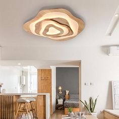 a living room filled with furniture next to a kitchen