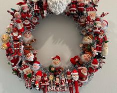 a christmas wreath with santa claus and other holiday decorations