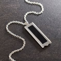 Find the Silver & Black Rectangle Pendant by Bead Landing™ at Michaels. Add eye-catching style to a handcrafted necklace with this pendant from Bead Landing. A black rectangle in a silver setting, this pendant will make a striking piece on its own or paired with complementary stones and charms on a simple chain. Add eye-catching style to a handcrafted necklace with this pendant from Bead Landing. A black rectangle in a silver setting, this pendant will make a striking piece on its own or paired Modern Black Necklaces For Everyday Use, Modern Black Necklace For Everyday Use, Modern Black Necklace For Everyday, Modern Black Necklace With Large Pendant, Black Minimalist Necklace With Large Pendant, Minimalist Black Necklace With Large Pendant, Black Pendant Necklace For Everyday Use, Elegant Rectangular Necklace For Everyday Use, Minimalist Black Rectangular Jewelry