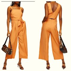 Sleeveless Wide Leg Jumpsuit By Topshop Is New With Tags! Dress It Up With Your Favorite Handbag & Heels Or Go Casual With A Straw Hat & Flip Flops!! Pale Apricot With Off White Lining Sleeveless Jumpsuit Has Squared Neckline, Cross Over Wrap V Back, Tie Waist, Cut Out Lower Back, Dual Slide Hip Pockets With Button Closure & Wide Legs Concealed Zipper Closure Shell: Viscose/Polyester Lining: Polyester/Cotton Size 6 (See Photo Of Measurements) No Flaws Or Damage 2628 New, Jumpsuit, Spring, Summer Chic Summer Tank Top With Pockets, Chic Tank Top With Pockets For Summer, Summer Workwear Jumpsuits And Rompers With Adjustable Straps, Sleeveless Jumpsuit With Adjustable Straps For Spring, Summer Sleeveless Jumpsuits And Rompers With Pockets, Sleeveless Summer Jumpsuits And Rompers With Pockets, Fitted Jumpsuits With Tie Straps For Day Out, Summer Sleeveless Jumpsuits With Tie Straps, Summer Sleeveless Jumpsuits And Rompers With Tie Straps