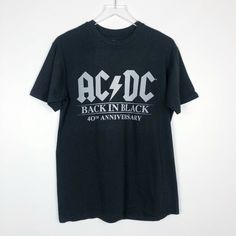 Ac/Dc Official Back In Black T-Shirt - Medium - Ultra Soft, High End Jersey - Official Ac/Dc Merchandise - Back In Black' 40th Anniversary Collection Please Contact Me With Any Questions! Black Band Merch T-shirt With Logo, Edgy Black T-shirt For Fan Merchandise, Black Short Sleeve Tops With Band Logo, Black Short Sleeve Top With Band Logo, Rock Style Band Logo T-shirt With Crew Neck, Black Band Logo T-shirt For Concert, Black Crew Neck T-shirt For Concert, Black Band Logo Crew Neck Top, Black Fan Merchandise Tops For Music Festivals