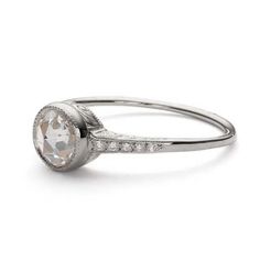 a white gold ring with an oval cut diamond in the center