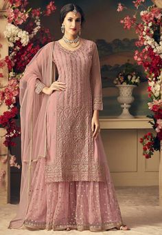 Semi-stitched net Pakistani Punjabi suit in dusty pink color. Product details: Semi-stitched Net Pakistani Punjabi suit in dusty pink This Round Neck and Full Sleeve attire with Poly Shantoon Lining is Prettified with Resham, Zari, and Patch Border Work Available with a Dusty Pink Net Sharara and a Dusty Pink Net Dupatta The Kameez and Bottom Lengths are 42 inches respectively Do note: The Length may vary up to 2 inches. The accessories shown in the image are for presentation purposes only. (Sli Pink Sharara, Sharara Suits, Pakistani Suit, Utsav Fashion, Salwar Kameez Designs, Designer Dresses Indian