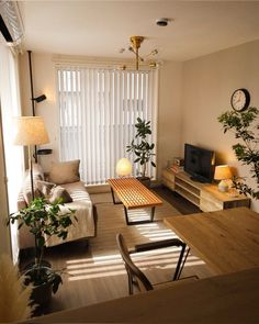 a living room filled with furniture and a flat screen tv sitting on top of a wooden table