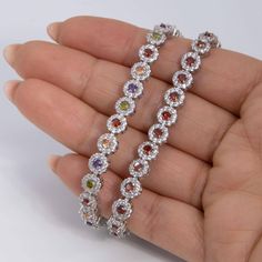 Round-Cut CZ Flower Tennis Bracelet Sterling Silver 925 * Metal : Real Sterling Silver (Properly Stamped, 925) * Condition : Brand New * Finish : Polished * Average Weight : 14.95 grams * Length : 7.25" * Width : 7mm = 1/4" * Clasp/Bail : Figure 8 Safety Clasp All of our items are brand new and are shipped with a gift box. Multicolor Round Sterling Silver Bracelet, Silver Multi-stone Flower Jewelry, Bracelet Tennis, Figure 8, Tennis Bracelet, Chain Link Bracelet, Sterling Silber, Link Bracelets, Sterling Silver Bracelets