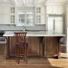 a kitchen with an island and two stools