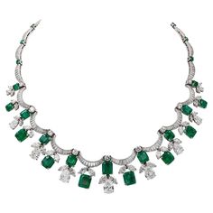 Twenty shimmering scalloped ribbons of baguette diamonds—twelve shallows and eight deeply curved—undulate around the neck interspersed with circular-cut emeralds and circular-cut diamonds and in this exquisitely designed Contemporary Diamond Emerald Fringe Festoon Bib Necklace, made in the 21st century. The sparkling piece harkens back to the luxury of Belle Époque jewelry, which portrayed Neoclassical and Rococo motifs of 18th-century French courts. Garlands and swags of foliate motifs, lace, a Rococo Motifs, Pear Shapes, Festoon Necklace, Jewelry Design Drawing, Stones Necklace, High Jewellery, Diamond Necklaces, Baguette Diamonds, Rich Green