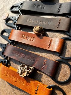 four leather keychains with personalized names on them