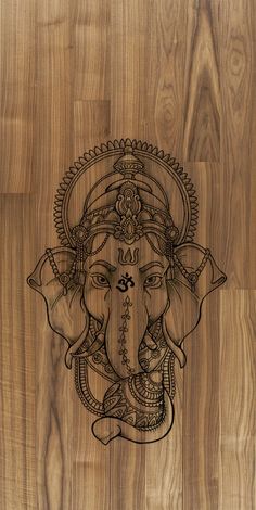 an intricately designed wooden wall with the face of ganesh