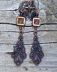 Long antique copper filigree earrings with Czech crystal and garnet gemstones. These long filigree earrings are very lovely, not too heavy! They are 3 inches long and 3/4 of an inch wide. The square table Kurt Czechoslovakian crystals really make the design pop. Garnet is the birthstone for January. All my jewelry comes gift boxed with a custom Shelly Mariposa Design butterfly card ready for gift giving, whether it is a gift for you or someone special. Your satisfaction is very important to me. Ornate Bronze Copper Jewelry, Antique Copper Dangle Earrings, Antique Copper Drop Earrings, Antique Copper Dangle Jewelry, Vintage Copper Jewelry With Intricate Design, Vintage Copper Brown Earrings, Vintage Brown Copper Earrings, Design Butterfly, Sunflower Pendant