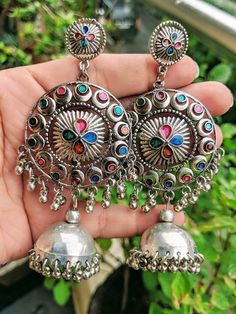 Add charm and charisma to your beautiful personality with these exquisitely handcrafted Afghani earrings jhumkas made with high quality German Silver. The intricate design and the glass enamel work renders these earrings a very unique and classy look. Pair them up with any formal or casual attire and gather compliments all the way!Weight  36 gmLength 4 inches Width 1.8" inches Multicolor Chandbali Jhumkas With Intricate Design, Multicolor Chandbali Earrings With Intricate Design, Multicolor Intricate Earrings For Navratri, Bohemian Dangle Jhumkas, Multicolor Temple Jewelry Danglers With Intricate Design, Bohemian Jhumkas With Intricate Design, Bohemian Metal Chandbalis Drop Earrings, Multicolor Oxidized Wedding Earrings, Multicolor Chandbalis With Intricate Design For Festivals