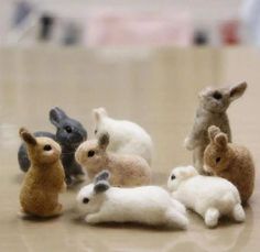 a group of small stuffed animals sitting on top of a table