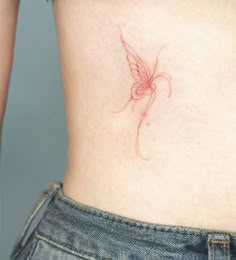 a woman's stomach with a small butterfly tattoo on her lower back and side