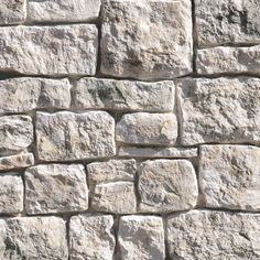 a stone wall made out of several different sized rocks