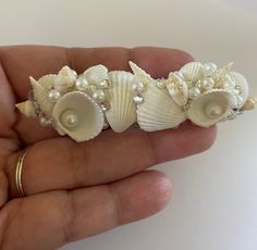 there is a small piece of jewelry that looks like seashells