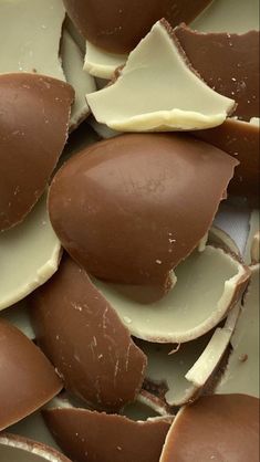 pieces of chocolate with white frosting on them sitting next to each other in a pile