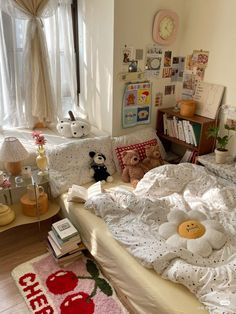 a bed with white sheets and teddy bears on it in a bedroom next to a window