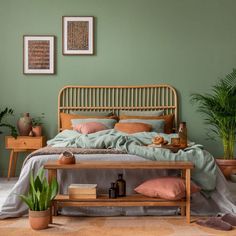 a bedroom with green walls and furniture in the corner, including a bed that has a bamboo headboard