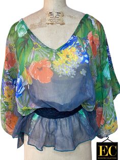 Floral Print Sheer Top - Eccentrik Collections, LLC Flowy Multicolor Beach Tops, Multicolor Flowy Beach Tops, Flowy Multicolor Tops For Spring, Floral Print V-neck Beachwear Top, Flowy Green Beach Tops, Flowy Green Top For Beach, Spring Beachwear Tops With Floral Print, Floral Print Beachwear Tops For Spring, Floral Print Tops For Spring Beachwear