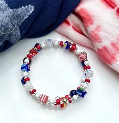 Celebrate the red, white and blue with this bright beaded glass bracelet with colorful milifiori and silver accents. Handmade. Make it a set with matching earrings! Red Czech Glass Bracelets With Colorful Beads, Nickel Free Multicolor Beaded Bracelets, Nickel-free Multicolor Beaded Bracelets, Patriotic Blue Jewelry With Colorful Beads, Patriotic Red Beaded Bracelets With Round Beads, Patriotic Red Beaded Bracelet With Round Beads, Red Beaded Jewelry For 4th Of July, Patriotic Red Beaded Bracelet, Red Jewelry With Colorful Beads For 4th Of July