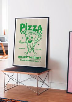 there is a pizza advertisement on the wall next to a table with a chair in front of it