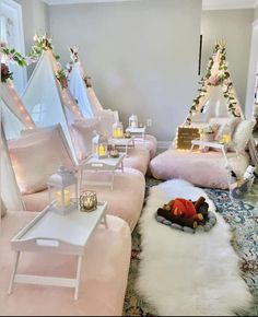 a living room filled with lots of pink furniture and decor on top of a rug