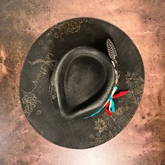 Rancher style cowboy hat for cowgirls custom burned by hand exclusively for Bourbon Cowgirl! We worked with this popular designer to create our very own look. 100% wool rancher hat in black which looks great with every outfit. One size fits all, as the interior band is adjustable to fit most. A beautiful rancher style with a pinch crease, this gorgeous black cowgirl hat is sanded and torched to a beautifully burnished and distressed finish. Firm shape (do not crush). Our artisan has hand burned Black Cowgirl Hat, Rancher Hats, Horse Flowers, Country Music Concerts, Black Cowgirl, Bullet Shell, Hand Burn, Rancher Hat, Pheasant Feathers