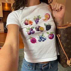 Fruit Baby Tee: SHIRT (Fruit of the Loom 3930BR): - Lightweight to mediumweight tee perfect for a hot and humid climate - 5 oz./yd², pre-shrunk 100% cotton - Garment weight: 5 oz/yd² (midweight) - High-density fabric knit for great print quality - Seamless 1x1 ribbed collar - Shoulder-to-shoulder taping for better shoulder fit - Double-needle stitched sleeves, bottom hem and front neck for wash durability - Tear away label tag PRINT: Our shirts are printed with Direct-To-Garment printing, which Purple Y2k Tops For Fall, Y2k Purple Tops For Fall, Y2k Style Purple Tops For Fall, Y2k Fall Purple Tops, Fitted 90s Inspired Summer Tops, Summer Y2k T-shirt With Fruit Print, Cute White Tops With Fruit Design, Fitted Summer T-shirt With Strawberry Print, Fitted Strawberry Print T-shirt For Summer