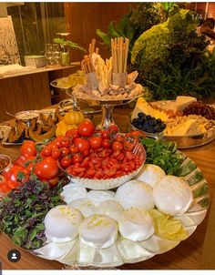 an assortment of food is displayed on a platter with other foods in the background