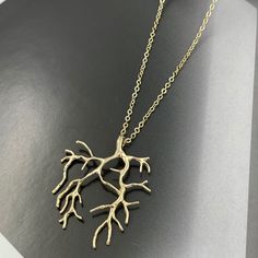 "❤️Deliver gifts on time with our recommended ship-by dates.❤️ - 16 DEC USPS first class mail - 18 DEC USPS Priority mail - 20 DEC USPS Priority mail express Channeling the mystique of the ocean's depths, the Gold Coral Branch Charm Necklace features a finely crafted gold pendant, reminiscent of intricate coral branches. This necklace offers a blend of natural inspiration and gleaming opulence, perfect for those looking to adorn themselves with a piece that echoes the wonders of the sea in luxurious gold. Measurements: Necklace length is 16\" plus 2 inches extender chain for adjustment. Branch is 30 mm x 38 mm This necklace would be a PERFECT GIFT for you and your family and friends! Comes beautifully packaged in a gift box!  Click here to see more Modern Necklaces: https://www.etsy.com/sh Gold Nature-inspired Necklace With Large Pendant, Gold Nature-inspired Metal Necklace, Gold Nature-inspired Pendant Necklace, Nature-inspired Gold Pendant Necklace, Green Wedding Jewelry, Green Statement Earrings, Forest Jewelry, Natural Inspiration, M Necklace