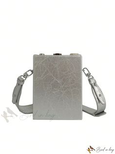 a small silver purse on a white background with a strap around the clasp and shoulder