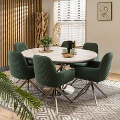 a dining room table with green chairs around it